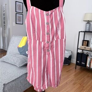 Striped button-front romper with cute back tie and adjustable straps.